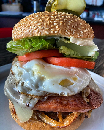 The Lumberjack 2.0: flattop Canadian beef burger with ham, fried egg, crispy onion strings, swiss cheese, lettuce, tomato, mayo and mango BBQ sauce at Rosie's on River Street, Moose Jaw, Saskatchewan
