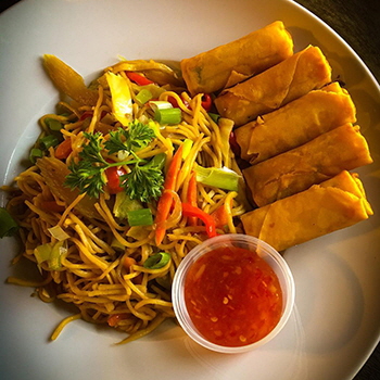 Stir fried noodles with vegetable spring rolls served with sweet chili sauce at The Rusty Owl, Prince Albert, Saskatchewan